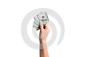 Female hand giving a bundle of dollar bills on white isolated background. Top view of power and wealth concept