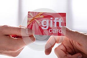 Female Hand Giving Gift Card To Her Partner