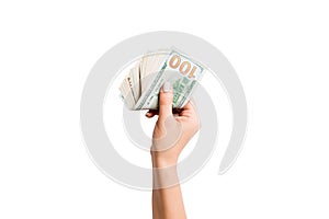 Female hand giving money on white isolated background. Top view of dollar banknotes. Bribe concept. Debt and loan concept