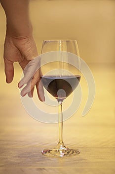 Female hand with a glass of red wine