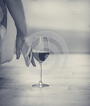 Female hand with a glass of red wine