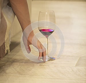 Female hand with a glass of red wine