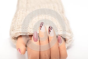 Female hand with glitter beige nail design. Glitter beige nail polish manicure. Female model hand with perfect manicure