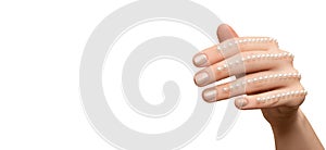 Female hand with glitter nail polish. Beige nail design. Women hand with sparkle manicure on white background