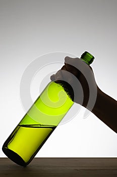 Female hand grabbing a bottle