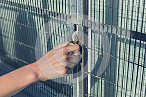 Female hand grabbing a padlock