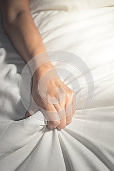 Female hand having sex on a bed