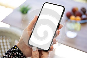 female hand hold phone with  screen background table cafe