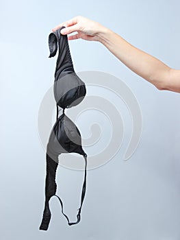 Female hand holding black bra photo