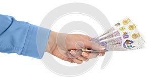 Female hand holding British pounds currency isolated with clipping path.