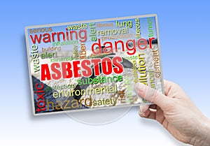 A female hand holding an card with asbestos theme