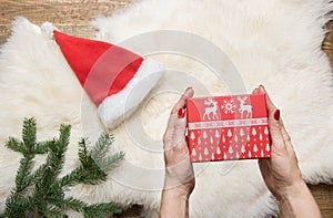 Female hand holding christmas gift box. Holiday concept. Winter.