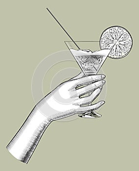 Female hand holding a cocktail with a orange slice