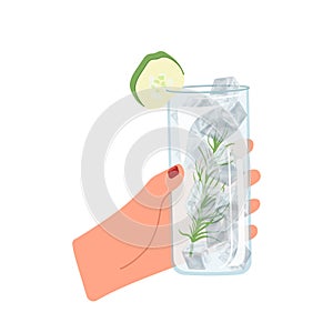 Female hand holding cold refreshment mojito non-alcoholic beverage in glass with lime slice