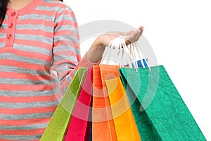 Female hand holding colorful shopping bags