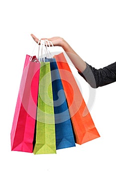 Female hand holding colorful shopping bags