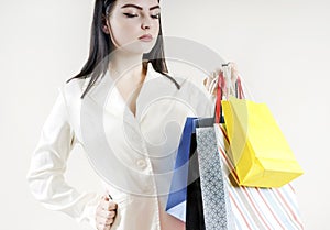 Female hand holding colorful shopping bags customer stylish