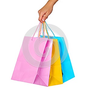 Female Hand Holding Colorful Shopping Bags isolated