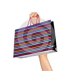 Female hand holding colorful shopping bags