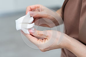 Female hand holding cotten pad. Beauty, spa, body care. Make-up removal