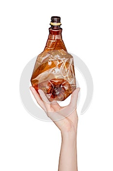 Female hand holding empty crushed plastic bottle isolated on white background. Recyclable waste. Recycling, reuse, garbage disposa