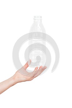 Female hand holding empty plastic bottle isolated on white. Recyclable waste. Recycling, reuse, garbage disposal, resources, envir