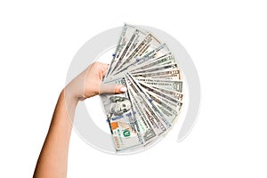 Female hand holding a fan of dollar banknotes on isolated background. Succes and investment concept