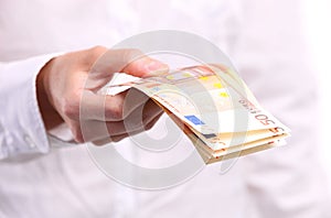 Female hand holding fifty euro banknotes