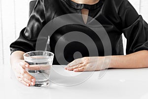 Female hand holding a glass of water