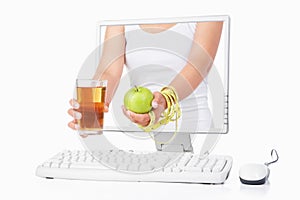 Female hand holding green apple and juice