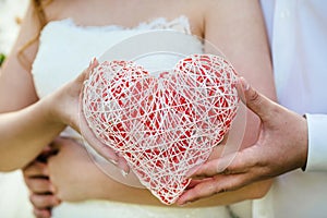 Female hand holding a heart symbol