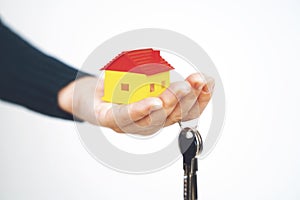 Female hand holding house key, real estate agent