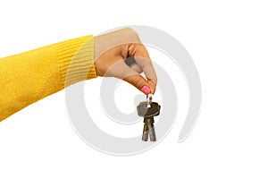 female hand holding house keys, suggesting