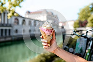 Female hand holding ice cream cone in Ljubljana city