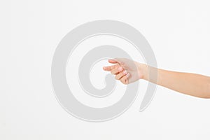 Female hand holding invisible items, woman`s palm making gesture while showing small amount of something on white isolated backgr