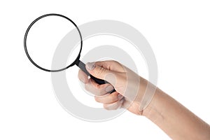 Female hand holding the magnifying glass (isolated