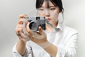 Female hand holding modern camera mirrorless camera. camera in hand. Focus camera