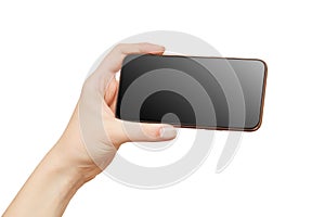 Female hand holding modern mobile phone with black screen isolated at white background. Cellphone mockup