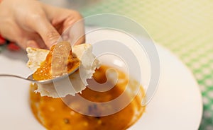 Female hand holding the nan bread with the Egyptian curry food and eat with the bread, For the Egyptian stye at the restaurant