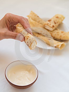 Female hand holding pancake roll