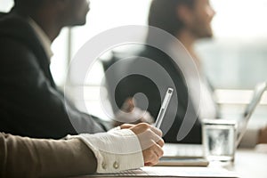 Female hand holding pen making notes at meeting, closeup view