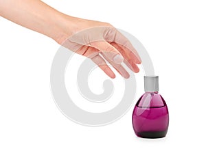 Female hand holding perfume bottle. Isolated on white background