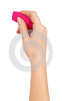 Female hand holding a pink eraser to erase