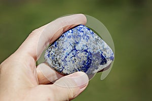 Female hand holding processed gemstone