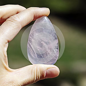 Female hand holding processed gemstone
