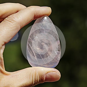 Female hand holding processed gemstone