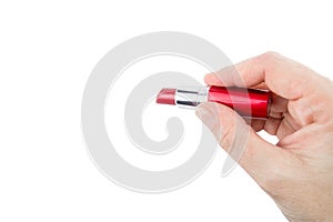 Female hand holding red open lipstick, isolated on white background