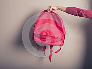 Female hand holding a rucksack