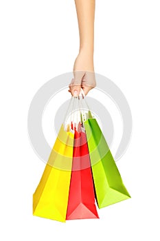 Female hand holding shopping bags, isolated on white background