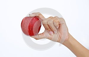 Female hand holding and showing a red apple on white background